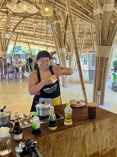 Liana at a Thai cooking class in an open-air kitchen